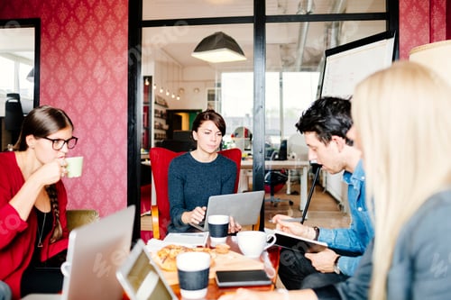 Preview: Business people discussing at table in office