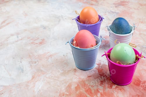 Preview: front view colored easter eggs inside separate little baskets on light background ornate spring