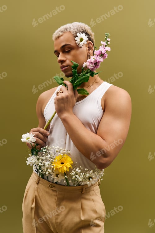 Preview: Young black man showcases vibrant style with flowers in trendy studio setting