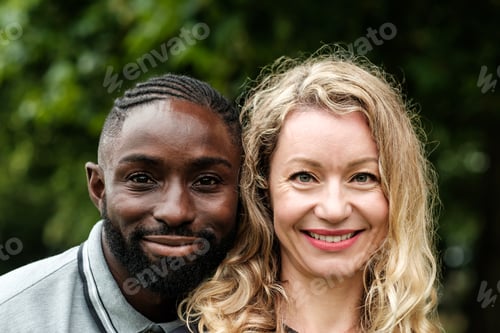 Preview: Interracial couple smiling together outdoors in nature