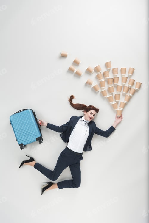 Preview: overhead view of cheerful businesswoman with suitcase and disposable cups isolated on grey