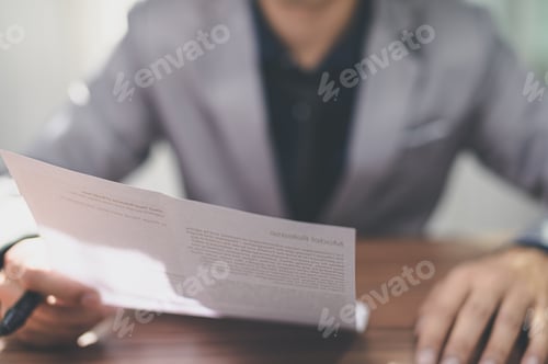 Preview: businessman reading documents income