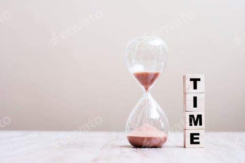 Preview: Hourglass on table, Sand flowing through the bulb of Sandglass measuring the passing time