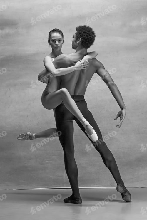 Preview: Couple of ballet dancers posing over gray background