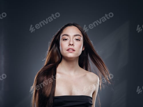 Preview: Beautiful woman smooth long hair brunette natural make up beautiful female portrait dark background