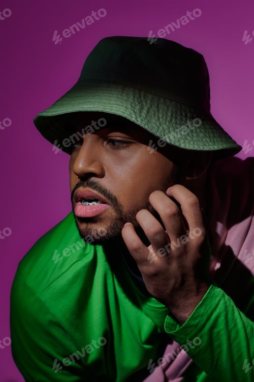 Preview: stylish african american man with earring and braces looking away with open mouth, fashion concept