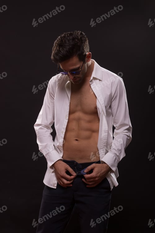 Preview: Young Man Posing Unbuttoned Shirt Unzipping Pants Black Background Studio