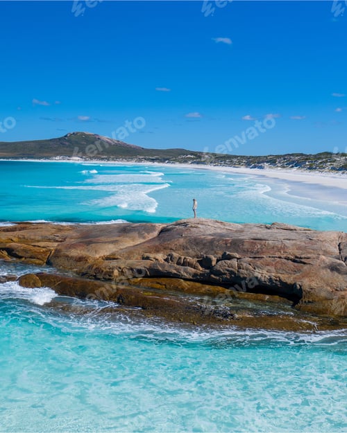 Preview: Pristine beach with turquoise waters and clear sky.