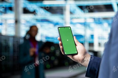 Preview: Green screen smartphone used by data center engineer