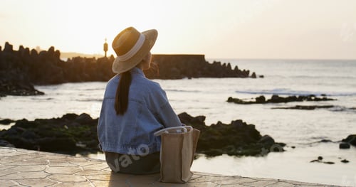 Preview: Woman look at the sunset view of the beach