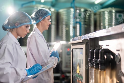 Preview: Caucasian female scientist working in laboratory at factory warehouse.