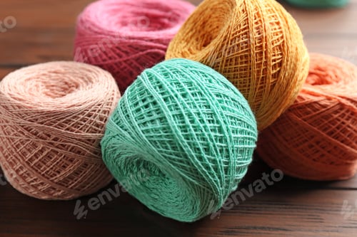 Preview: Colorful clews of threads on wooden table, closeup