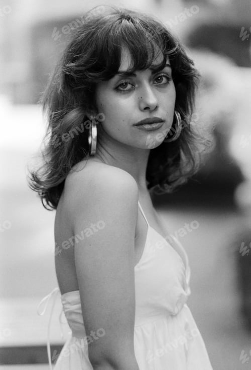Preview: Classic monochrome portrait of beautiful woman in white summer dress and looking at camera.