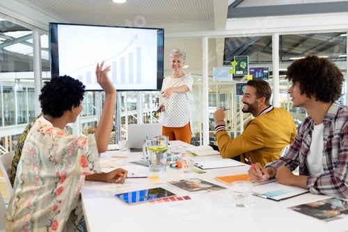 Preview: African american businessman raising hand in presentation during meeting