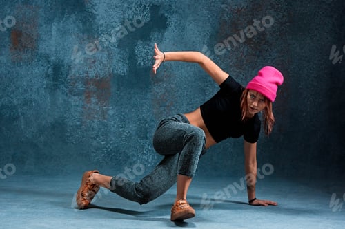 Preview: Young girl break dancing on wall background.