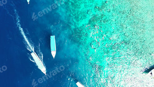 Preview: Aerial view of boats sailing in the turquoise ocean in the Maldives