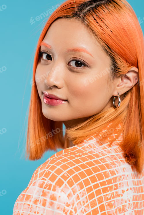 Preview: portrait of young asian woman with natural makeup, lip gloss, hoop earrings and short dyed hair