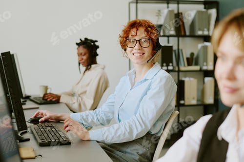 Preview: Woman Smiling and Working in Modern Office Setting