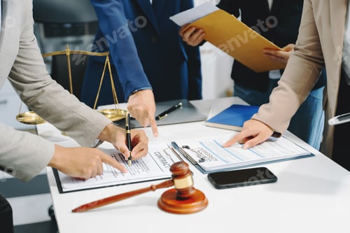 Preview: business people and lawyers discussing contract papers sitting at the table.