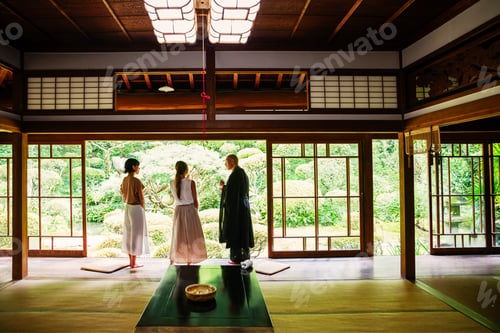 Preview: Buddhist priest and two Japanese women standing in Buddhist temple.