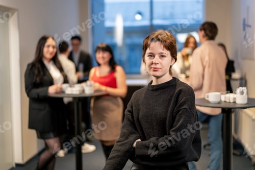 Preview: portrait of a young girl at a business conference during a coffee break working networking