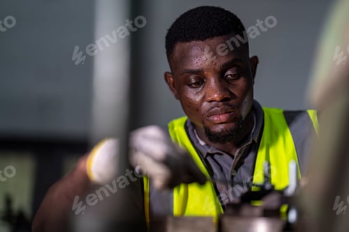 Preview: experienced technician operates a machine in a factory setting,