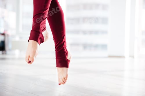 Preview: Beautiful slim legs of sportswoman in the air