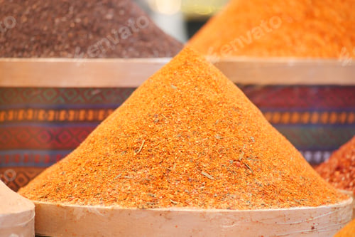 Preview: Vibrant spices displayed in market stalls during midday