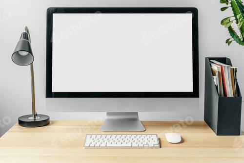Preview: Computer monitor with mockup white screen on office table with supplies