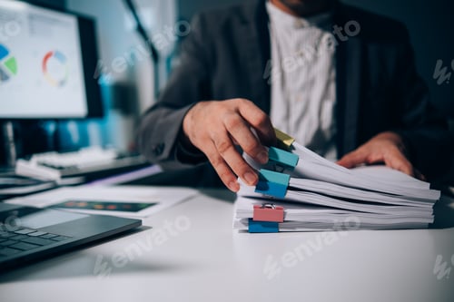 Preview: Work from Home, Businessman hands working in Stacks of paper files for searching information on work