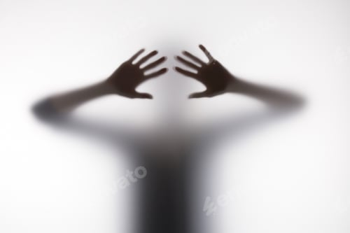 Preview: Blurry silhouette of person touching glass with hands