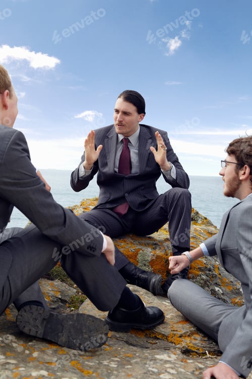 Preview: Businessmen talking on cliff