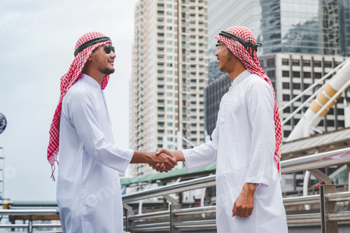 Preview: Arab Businessman shaking hands together. Teamwork business partner wear Muslim dress Shake Hands
