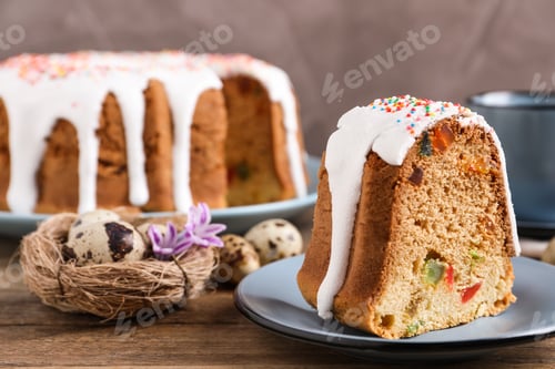 Preview: Piece of glazed Easter cake with sprinkles and candied fruits on wooden table, space for text