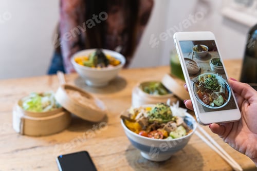 Preview: Anonymous woman taking photo of dish in restaurant