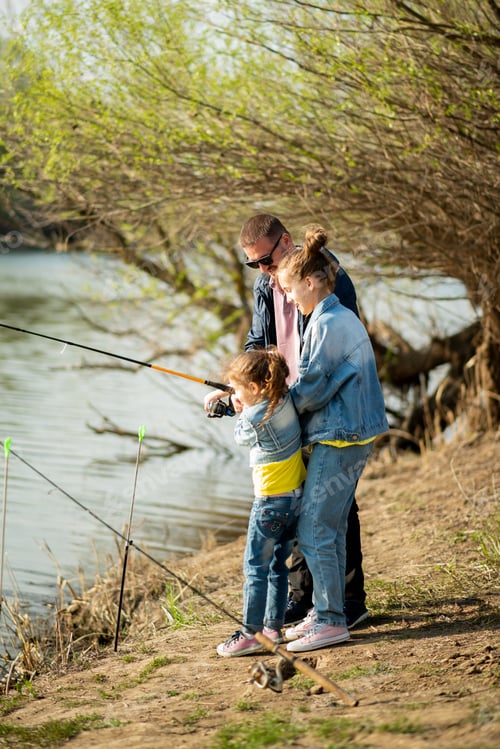 Preview: A dad and his two daughters are fishing in the river.