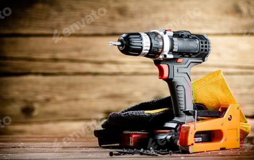 Preview: Cordless Drill and Tools on Wooden Background