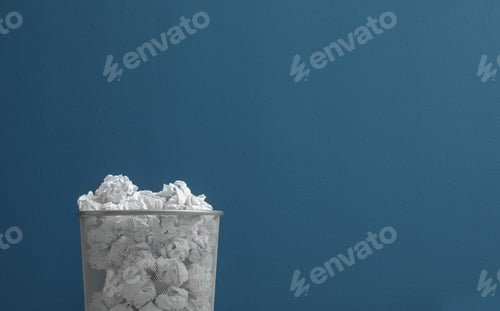 Preview: Metal bin with crumpled paper against color background. Space for text