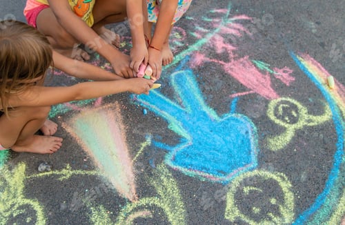 Preview: Children draw with chalk on the asphalt. Selective focus.