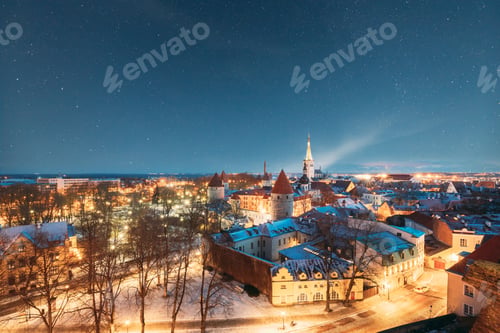 Preview: Tallinn, Estonia. Night Starry Sky Above Old Castle Walls Architecture. Cityscape Skyline In Old