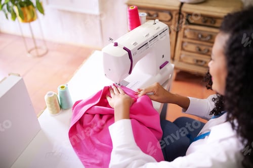 Preview: Seamstress Lady Sewing At Machine Sitting In Modern Dressmaking Atelier