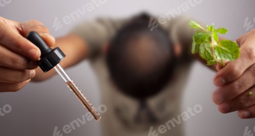 Preview: bald man showing visible scalp with essential oil and Peppermint leaves