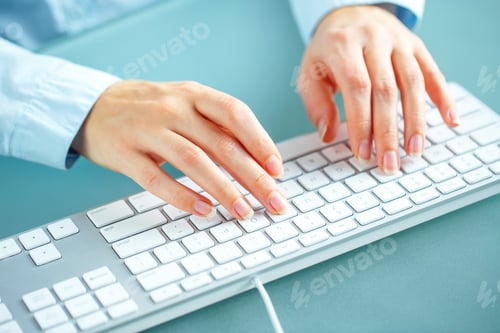 Preview: Woman office worker typing on the keyboard