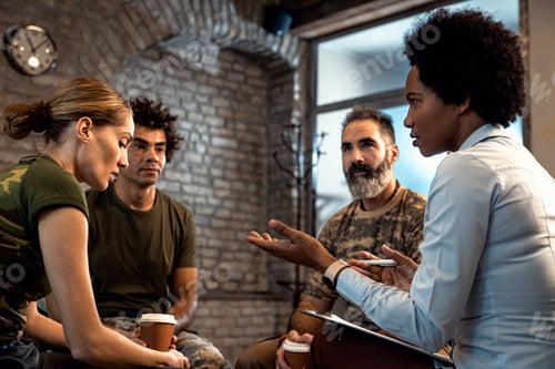 Preview: Group of diverse veterans talking during PTSD support group.