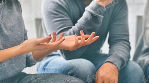 Preview: Unrecognizable woman sharing story on group therapy session and emotionally gesturing