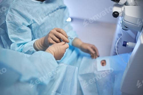 Preview: Surgeon Handing Surgical Instrument to Assistant in Operating Room