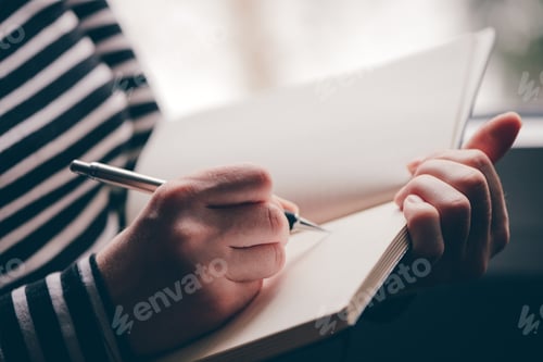 Preview: Woman writing diary by the window