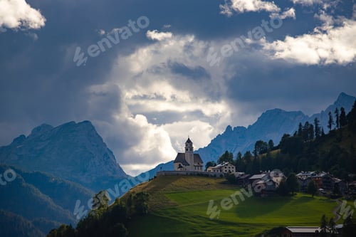 Preview: Rocca Pietore village, with his small church located at the foot of the Marmolada, Dolomites