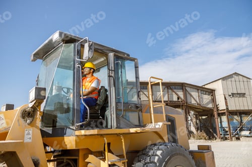 Preview: Multiracial construction worker using heavy machinery in plant