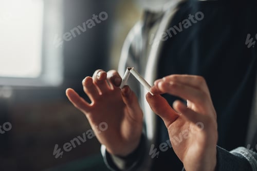 Preview: Addicted male person breaks a cigarette